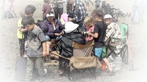 Ktunaxa community members teaching youth about peeling Bitterroot at the dig.