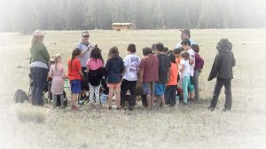 Hereditary Chief Sophie Pierre teaching Ktunaxa youth about traditional food preparation at the 2019 Bitterroot Dig.